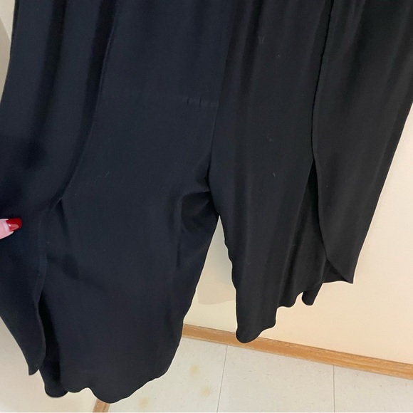 Melissa Nepton black off shoulder jumpsuit with flutter sleeves and tulip legs. - Picture 4 of 9